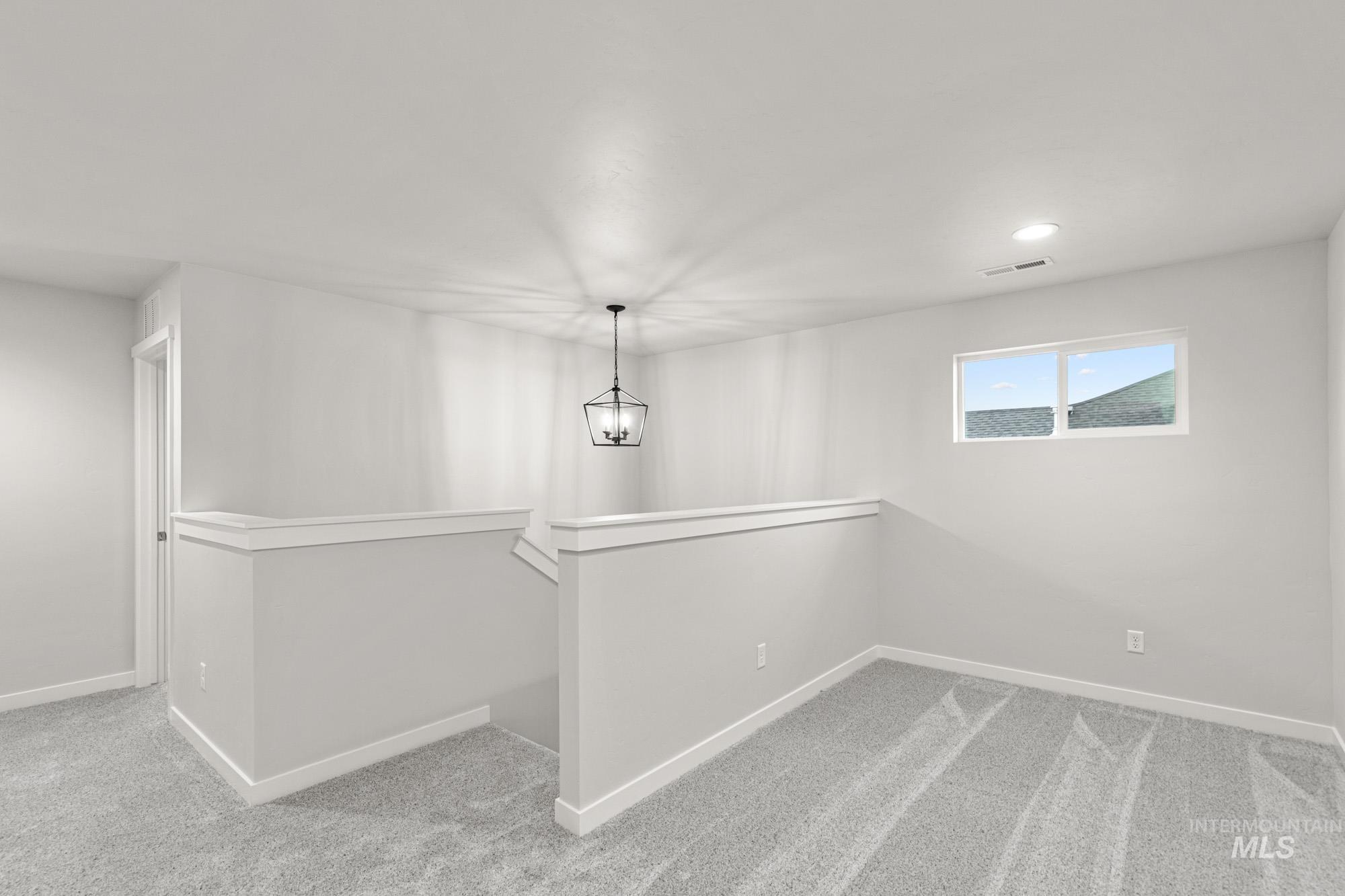 4287 South Red Sox Way Nampa, ID 83686 - Photo 13 of 22 Unfurnished dining area with light colored carpet, recessed lighting, and a chandelier