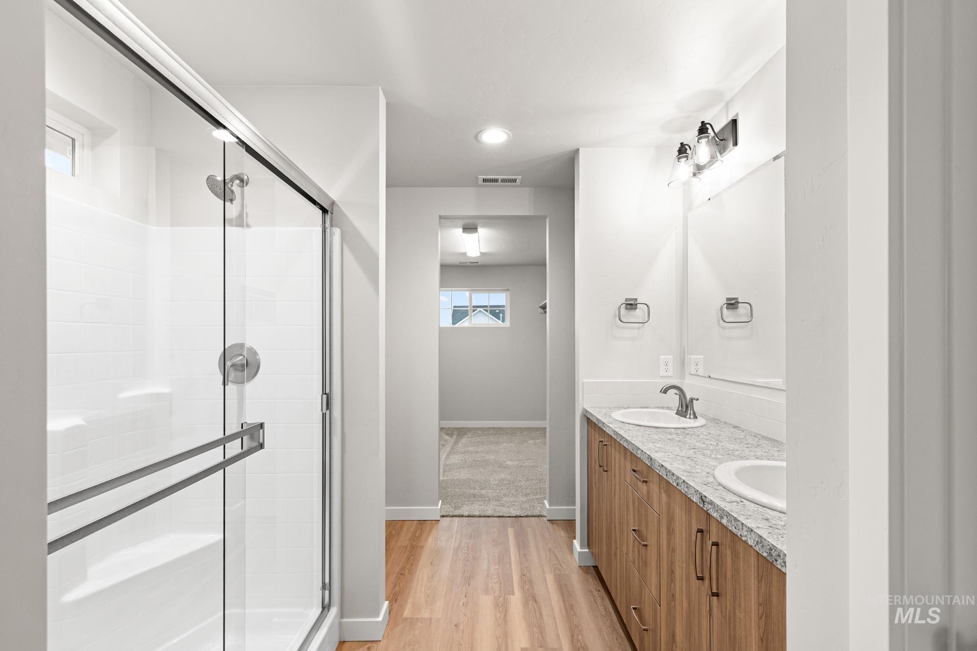 4287 South Red Sox Way Nampa, ID 83686 - Photo 15 of 22 Full bath with double vanity, a stall shower, light wood-style flooring, and recessed lighting