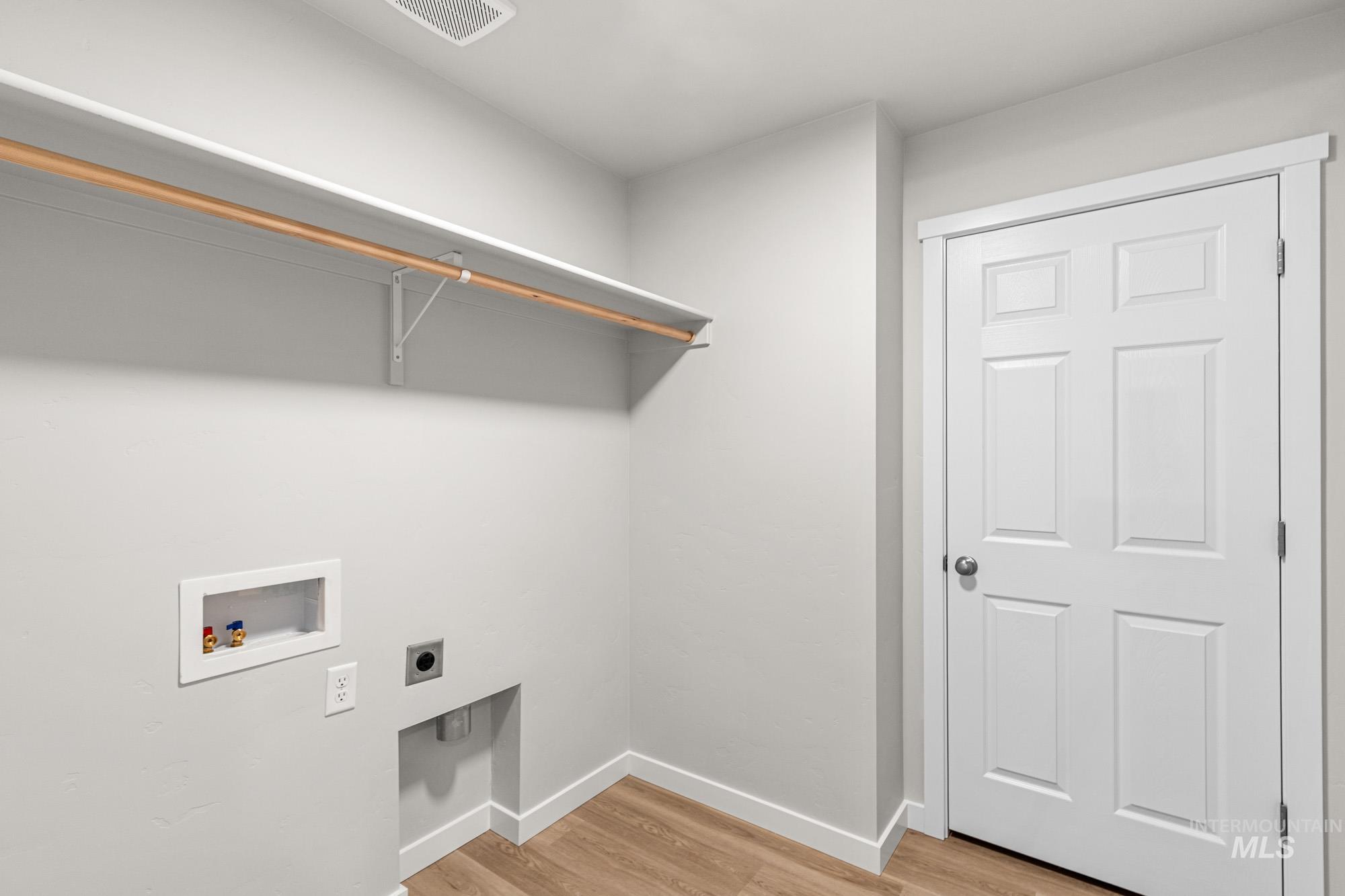 4287 South Red Sox Way Nampa, ID 83686 - Photo 17 of 22 Washroom featuring light wood finished floors, hookup for a washing machine, and electric dryer hookup