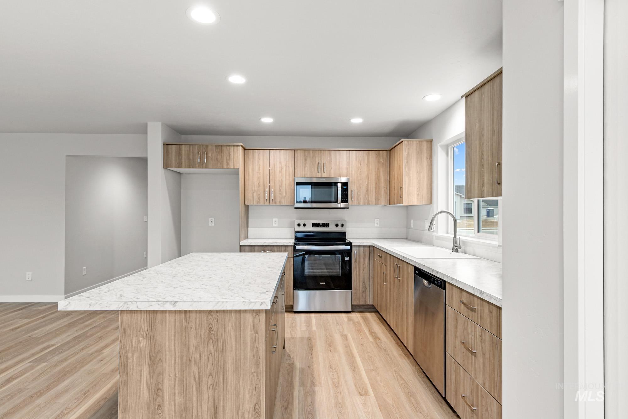 4287 South Red Sox Way Nampa, ID 83686 - Photo 5 of 22 Kitchen with stainless steel appliances, light countertops, modern cabinets, light wood-style floors, and recessed lighting