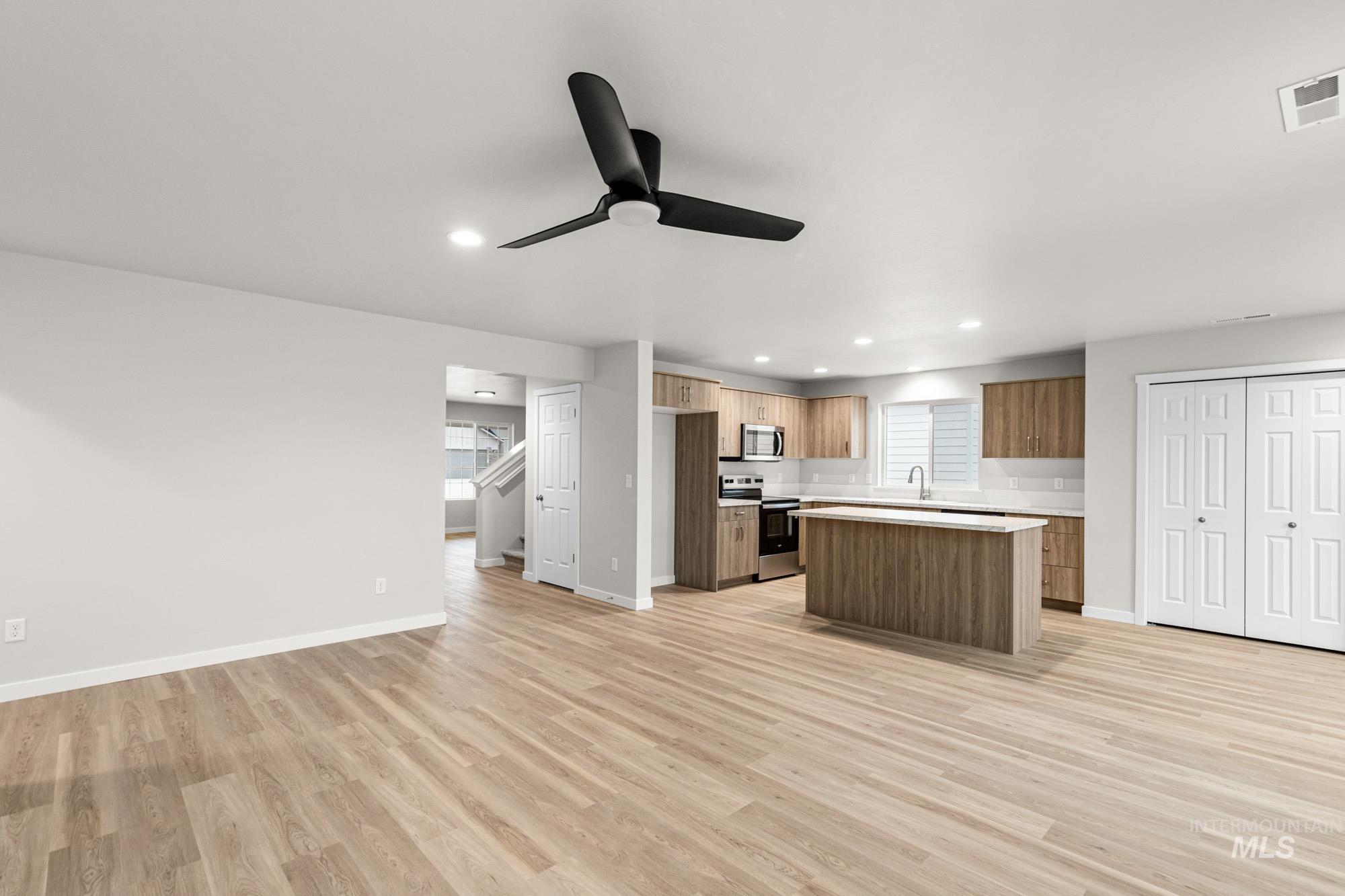 4287 South Red Sox Way Nampa, ID 83686 - Photo 21 of 22 Kitchen featuring open floor plan, stainless steel appliances, a kitchen island, a ceiling fan, and recessed lighting