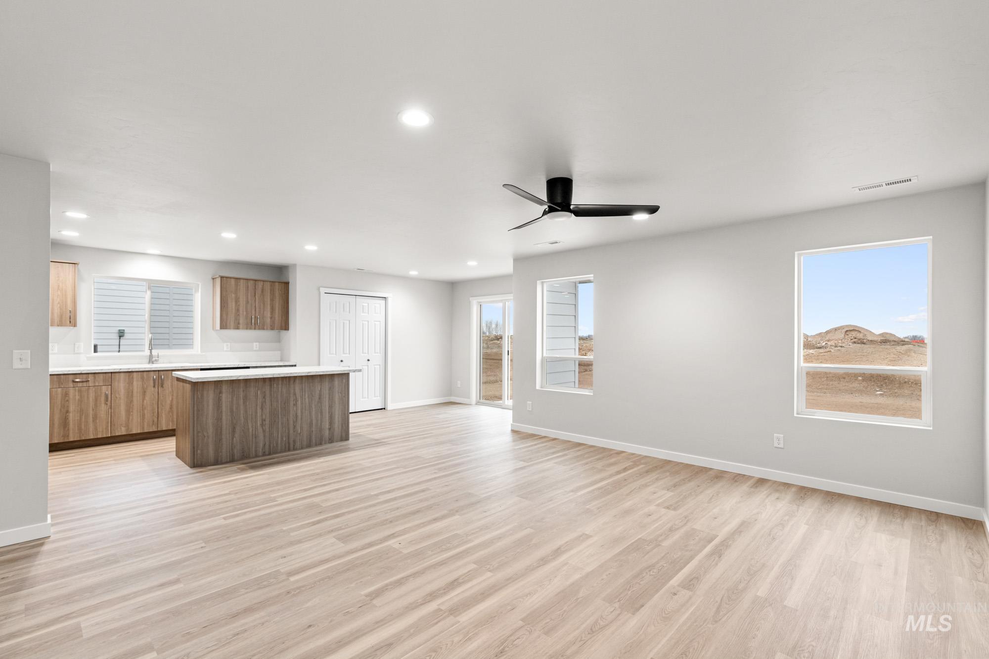 4287 South Red Sox Way Nampa, ID 83686 - Photo 22 of 22 Kitchen featuring a center island, open floor plan, light countertops, light wood-style flooring, and ceiling fan