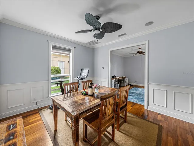 a view of a dining room with furniture and a window