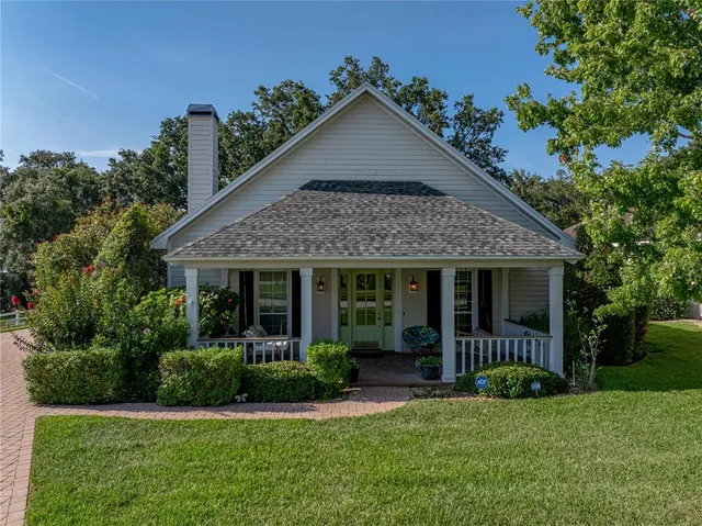 a view of a house with garden and porch