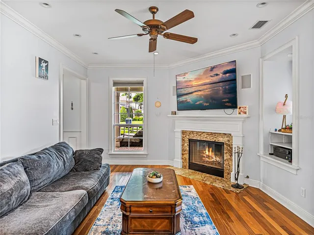 a living room with furniture a flat screen tv and a fireplace