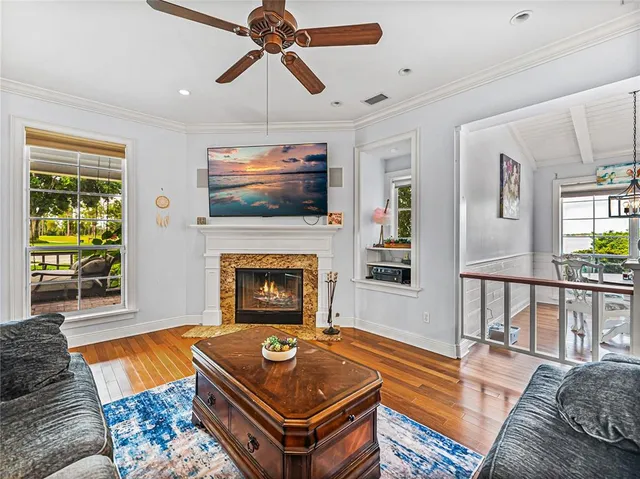 a living room with furniture a flat screen tv and a fireplace