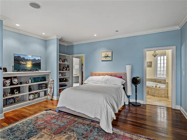 a bedroom with a bed and a bookshelf