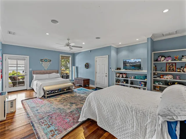 a bedroom with a bed a dresser and book shelf