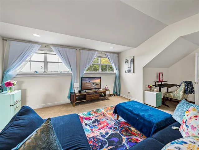 a bedroom with furniture and a wooden floor