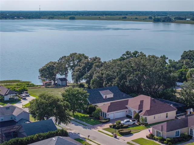 an aerial view of a house with a lake view