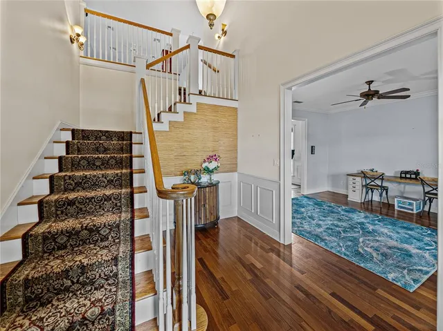 a view of entryway and hall with wooden floor