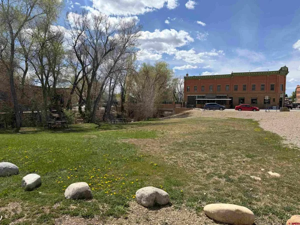 a backyard of a house with table and chairs