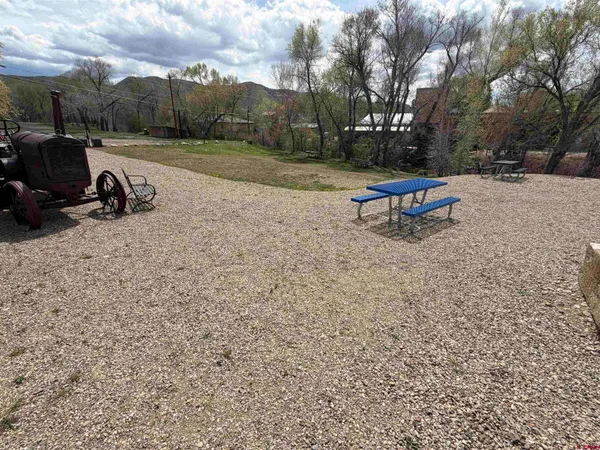 a backyard of a house with table and chairs