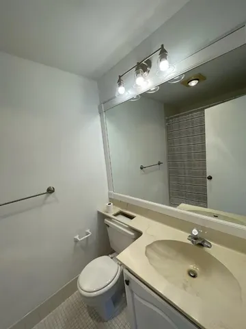 a bathroom with a glass shower door