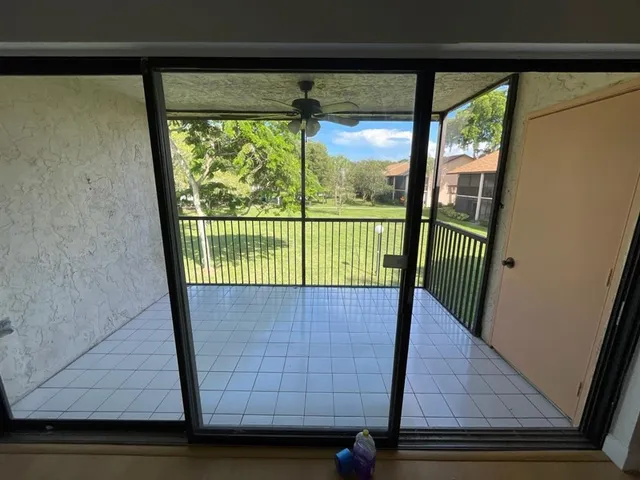 a view of staircase with railing and a chandelier