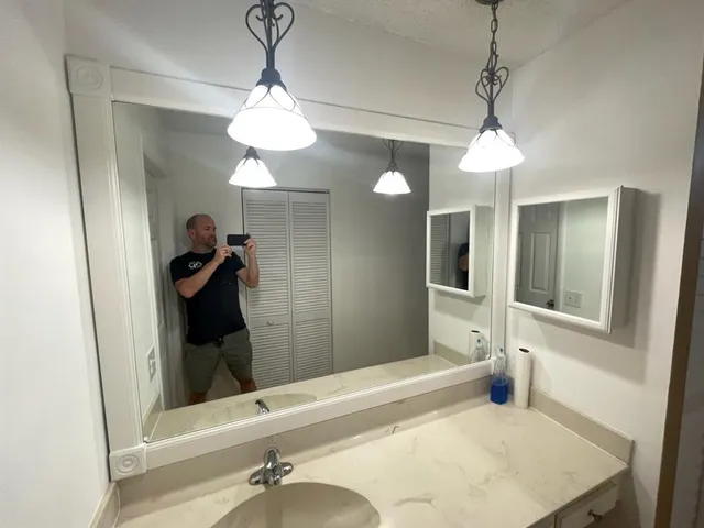 a bathroom with a sink a toilet and mirror