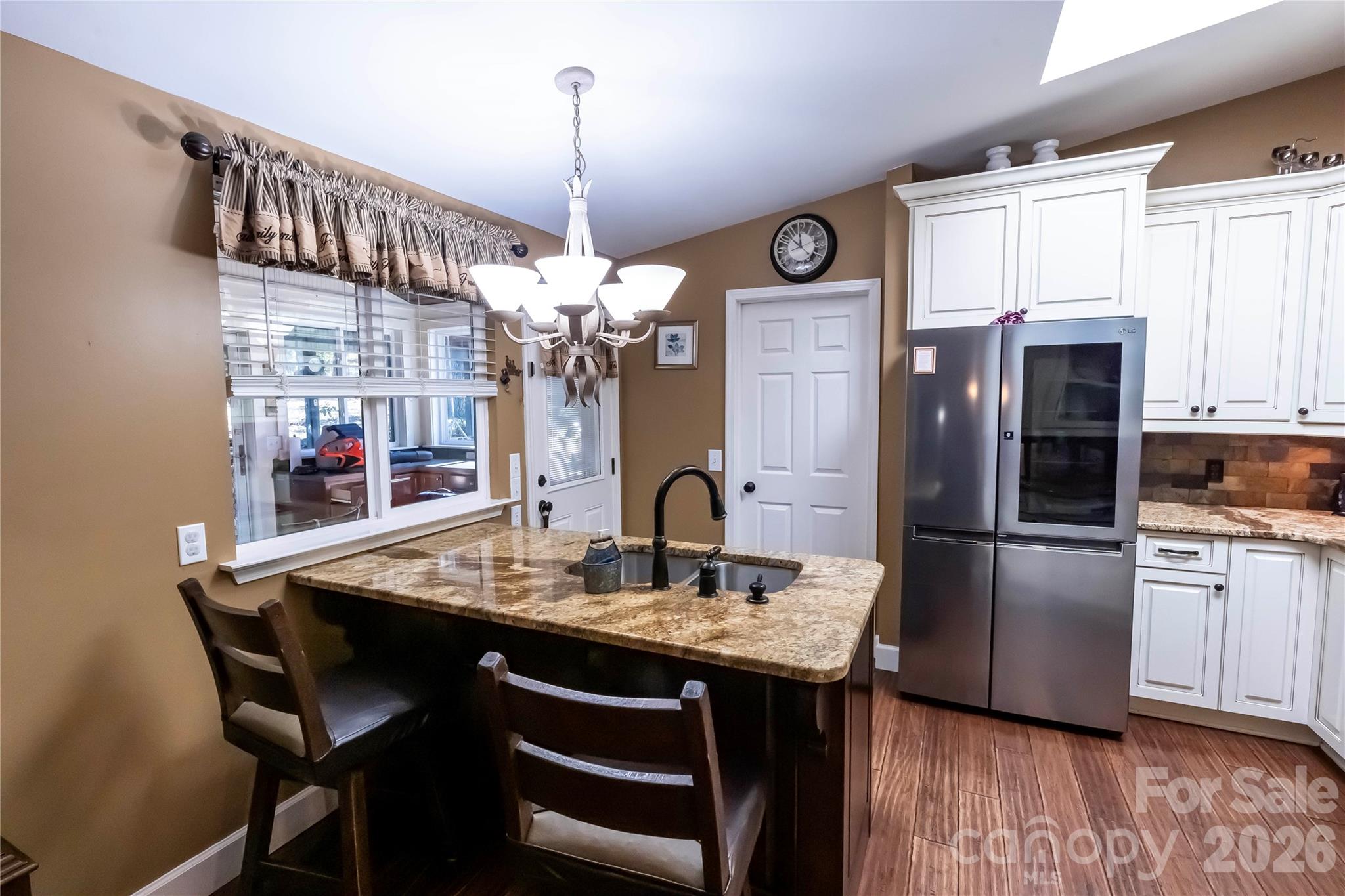 1264 Lilly Drive Clover, SC 29710 - Photo 4 of 37 a kitchen with stainless steel appliances granite countertop a dining table chairs refrigerator and sink
