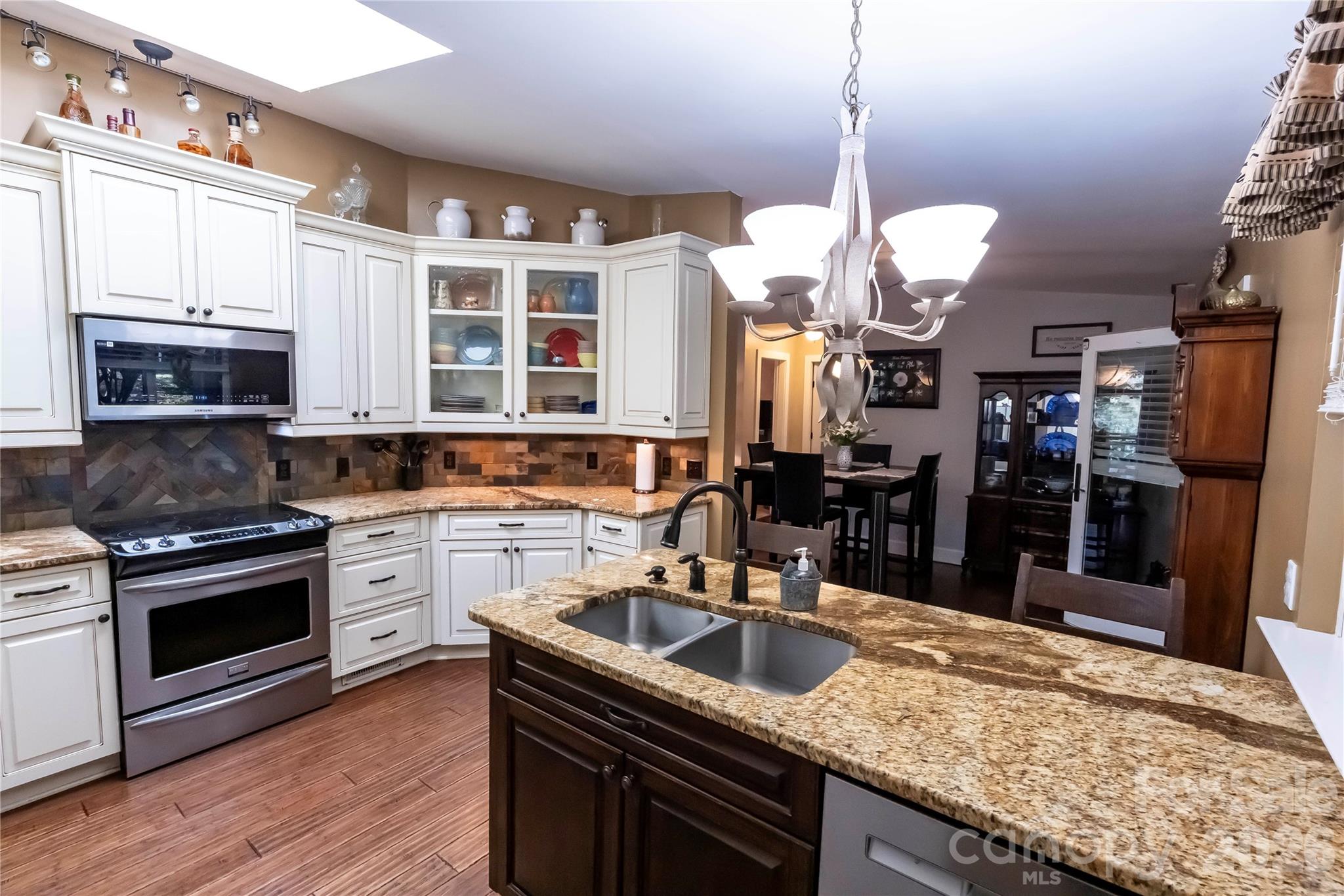 1264 Lilly Drive Clover, SC 29710 - Photo 6 of 37 a kitchen with stainless steel appliances granite countertop a sink a stove and a wooden cabinets