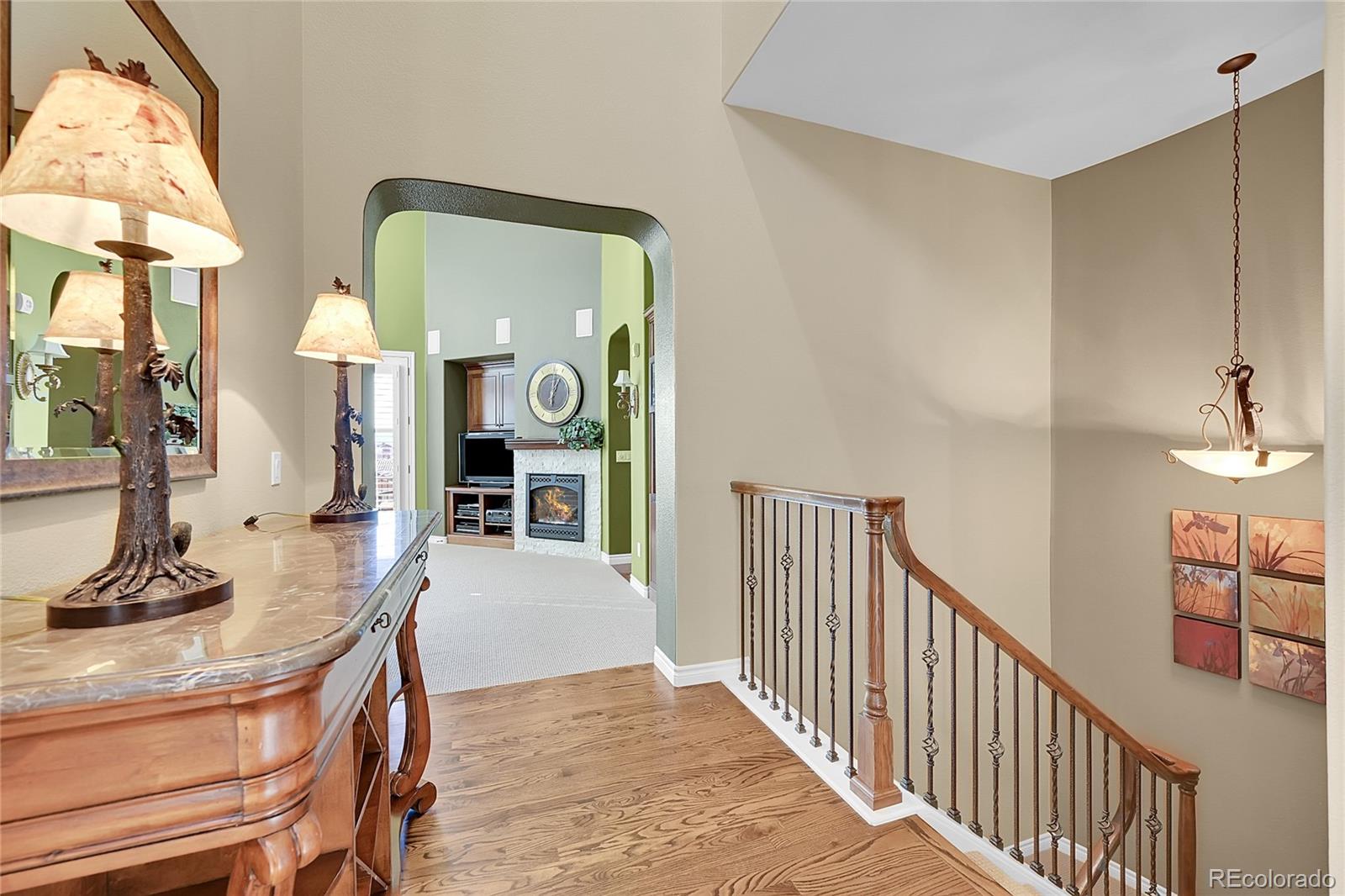 9401 Viaggio Way Highlands Ranch, CO 80126 - Photo 16 of 46 a view of a hallway with a livingroom and a chandelier