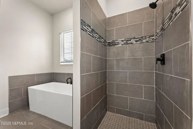 a bathroom with a bathtub and shower