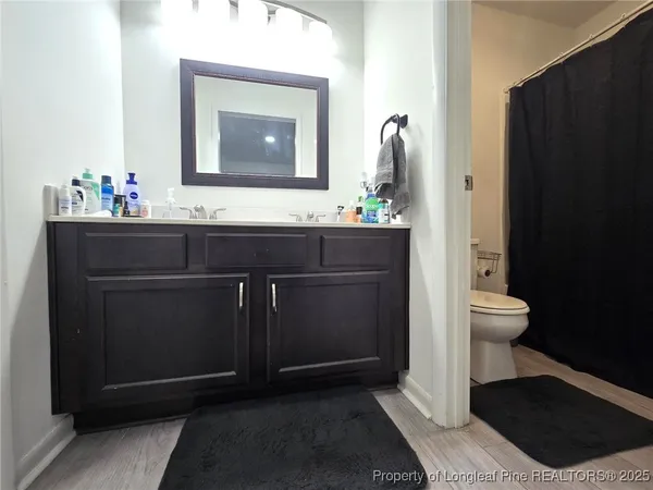 a bathroom with a sink a toilet and mirror