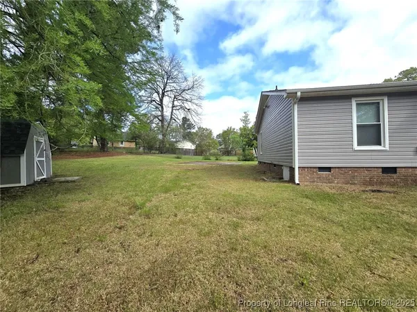 a view of a backyard with large trees