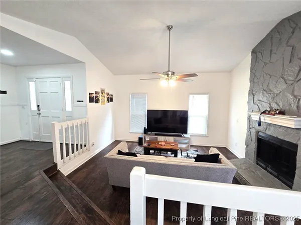 a living room with furniture and a flat screen tv