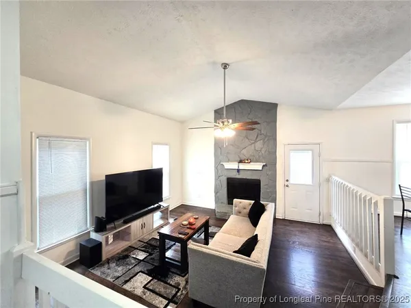 a living room with furniture and a flat screen tv