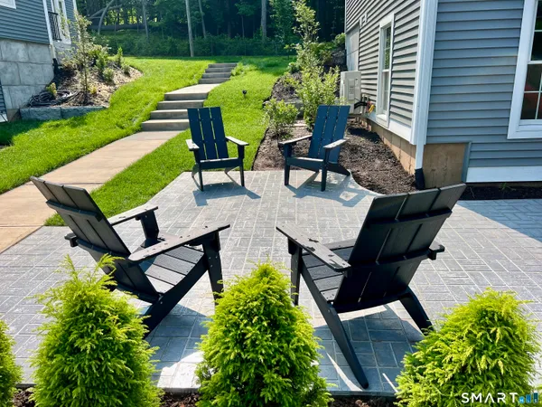 a view of a backyard with sitting area