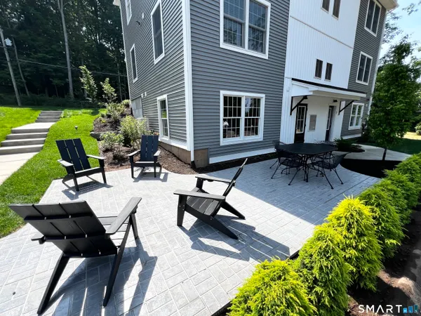 a swimming pool with outdoor seating and yard