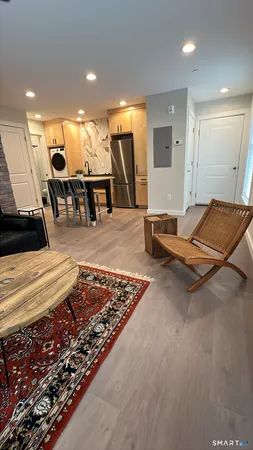 a living room with lots of furniture and a rug