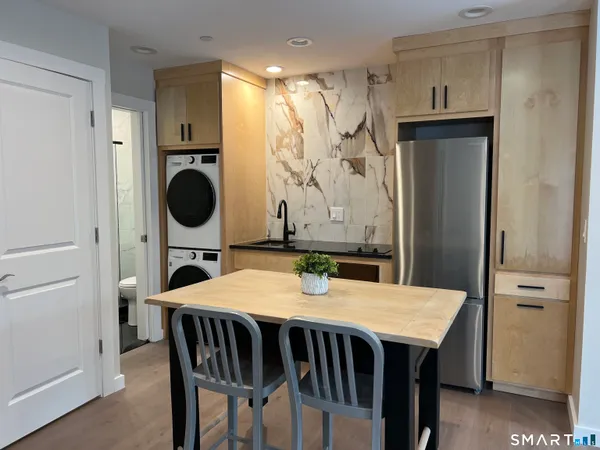a dining room with furniture and window
