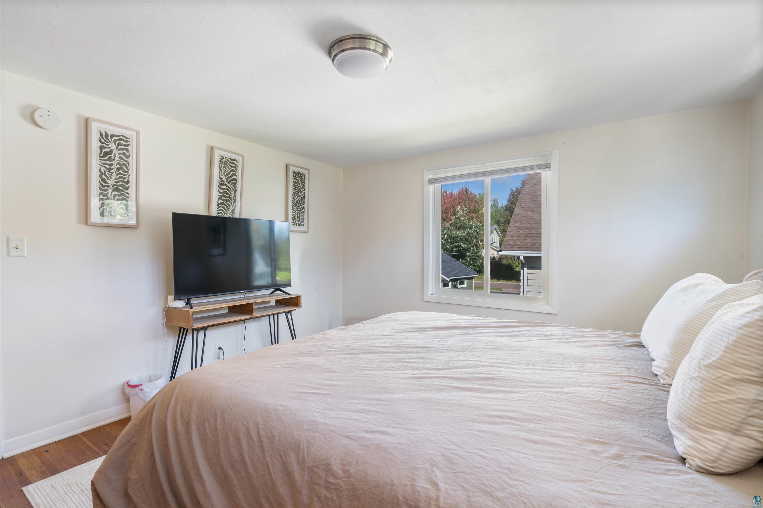 3715 Rendle Avenue Duluth, MN 55803 - Photo 9 of 20 Hardwood flooring, painted walls, and a ceiling-mounted light fixture