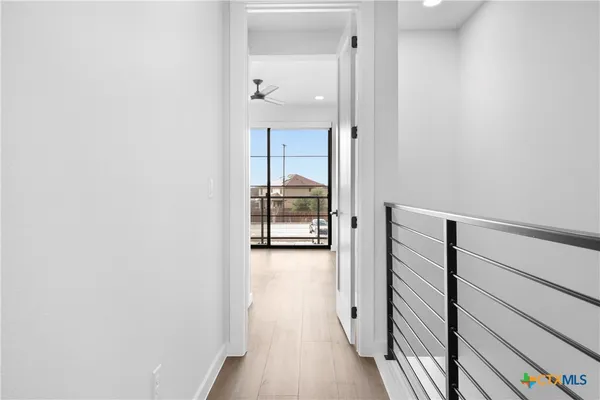 a view of a room with wooden floor