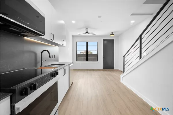 a kitchen with granite countertop a stove and a sink