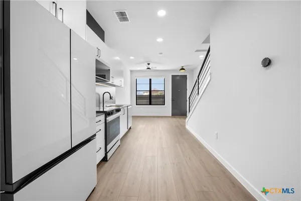 a view of a kitchen cabinets and wooden floor