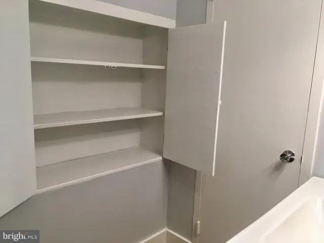 a bathroom with a sink mirror vanity and toilet