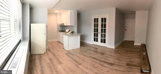 a view of kitchen with cabinets and wooden floor