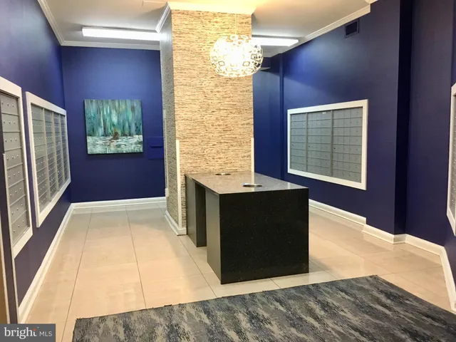 a lobby with furniture and a potted plant