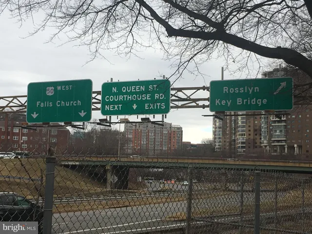 a view of a street with a building in the background