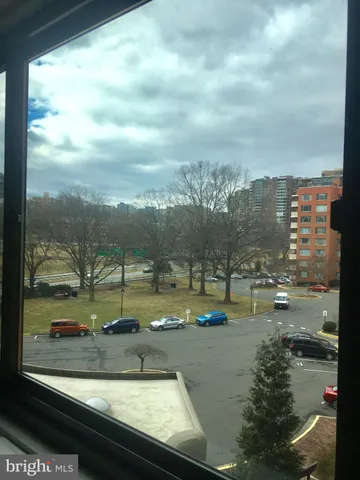 a front view of a building with parking space