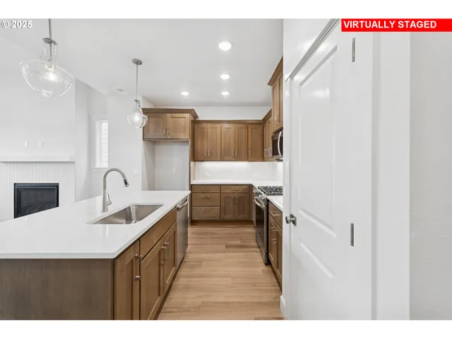 a kitchen with kitchen island a sink appliances and cabinets