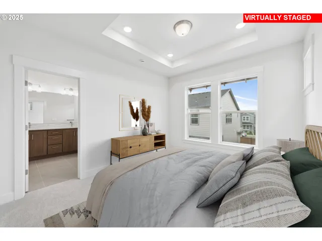 a bedroom with a large bed and a large window