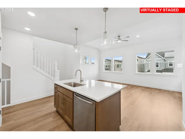 a kitchen with a sink a counter space and a window