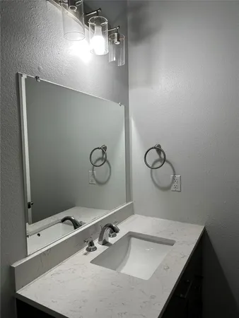 a bathroom with a sink vanity and a mirror
