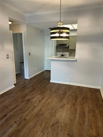 a view of a kitchen with a sink and wooden floor