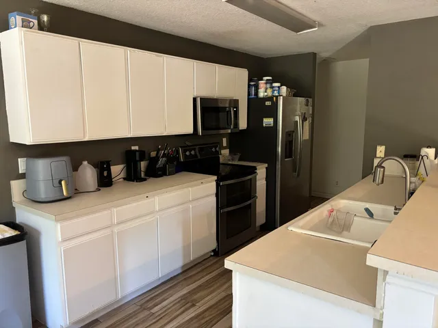 a kitchen with a sink and refrigerator
