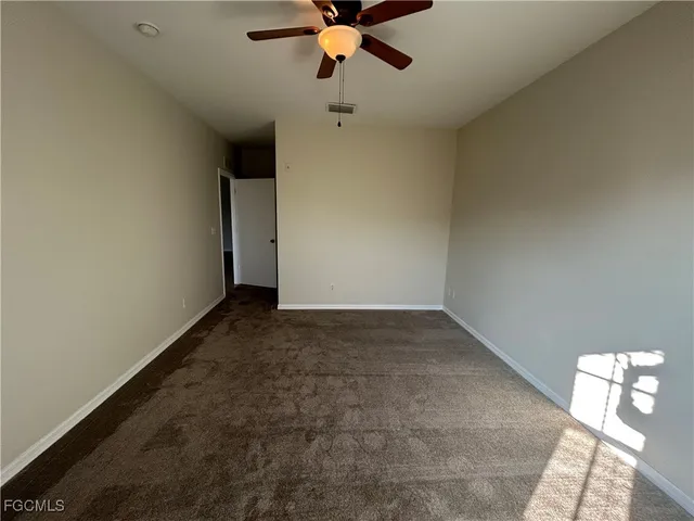 a view of empty room with ceiling fan