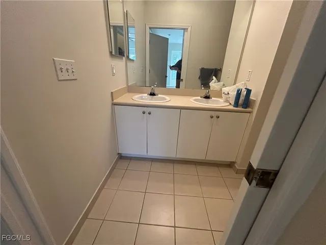 a bathroom with a sink a vanity and a mirror