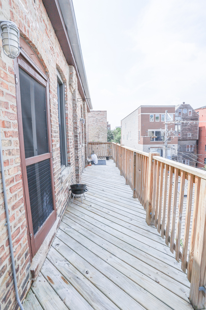 3500 North Reta Avenue, Unit 2 Chicago, IL 60657 - Photo 12 of 12 a view of a balcony with wooden floor and fence
